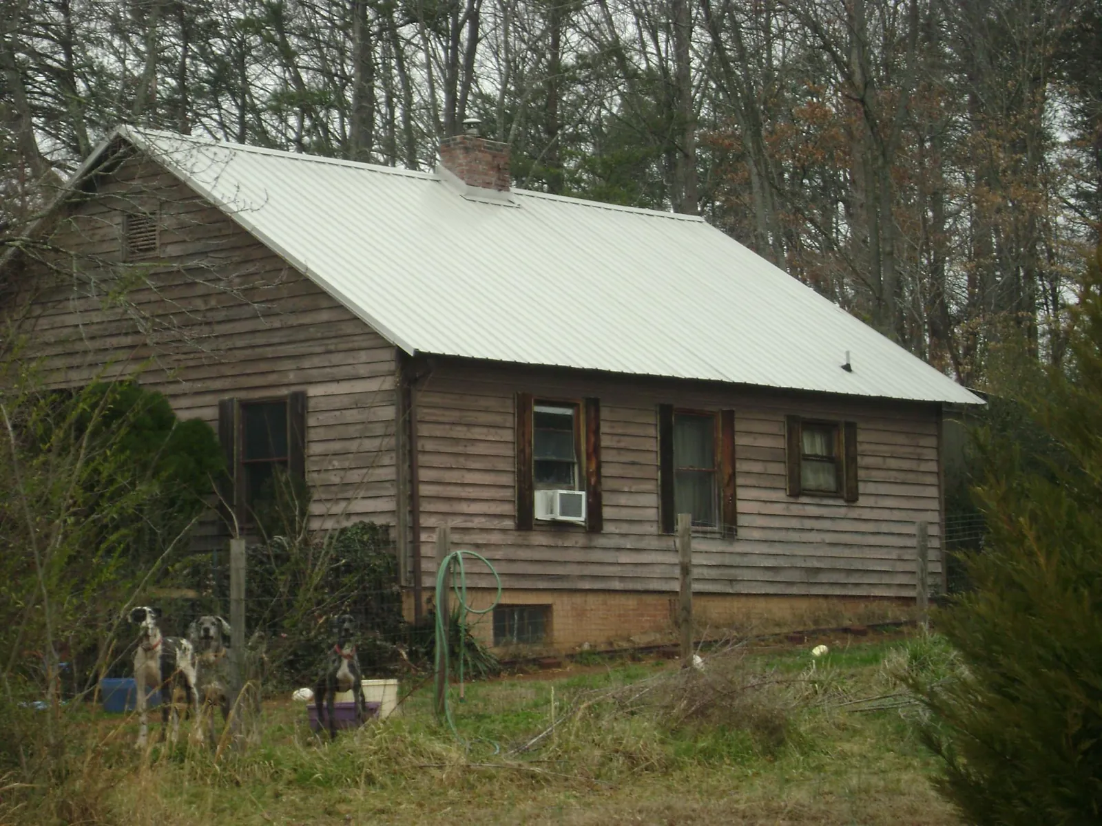White metal roof on an old wood sided farmhouse, from a Metal Roof Installation job in Johnson City