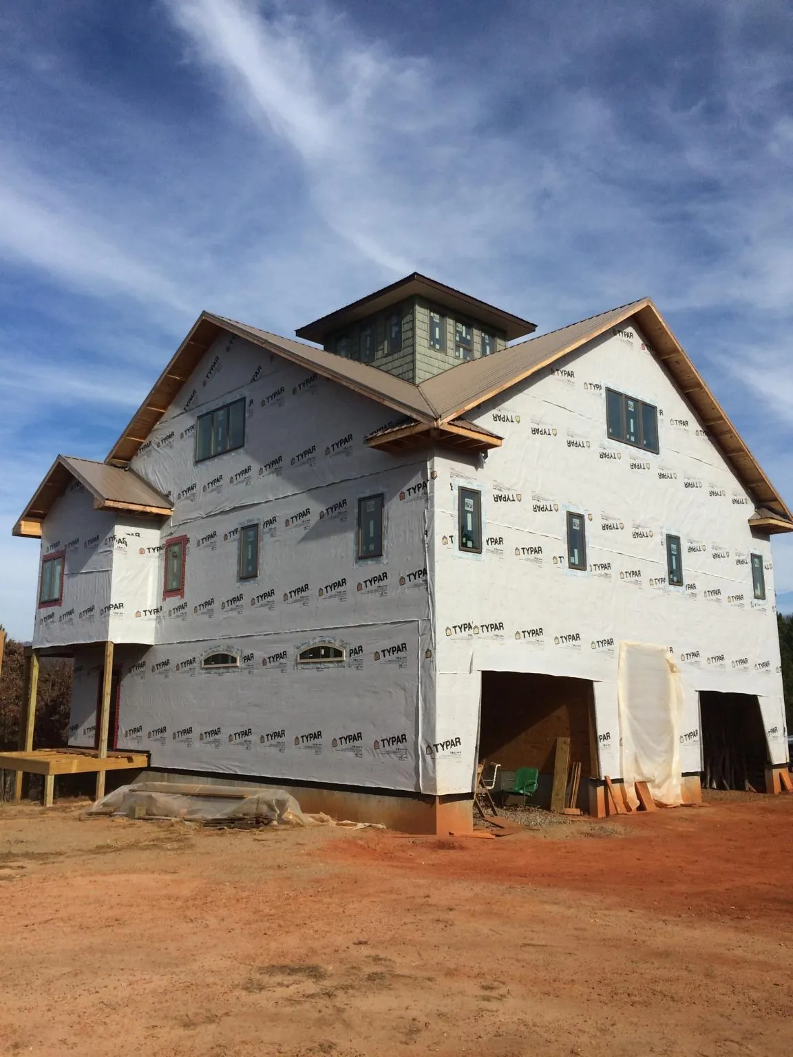 New two story house under construction with a cupola and gabled roofs in Johnson City